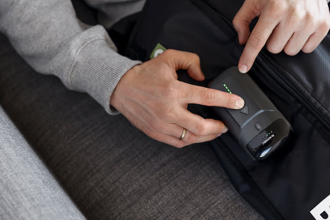 Compression boots in use with pressure level settings visible on side panel