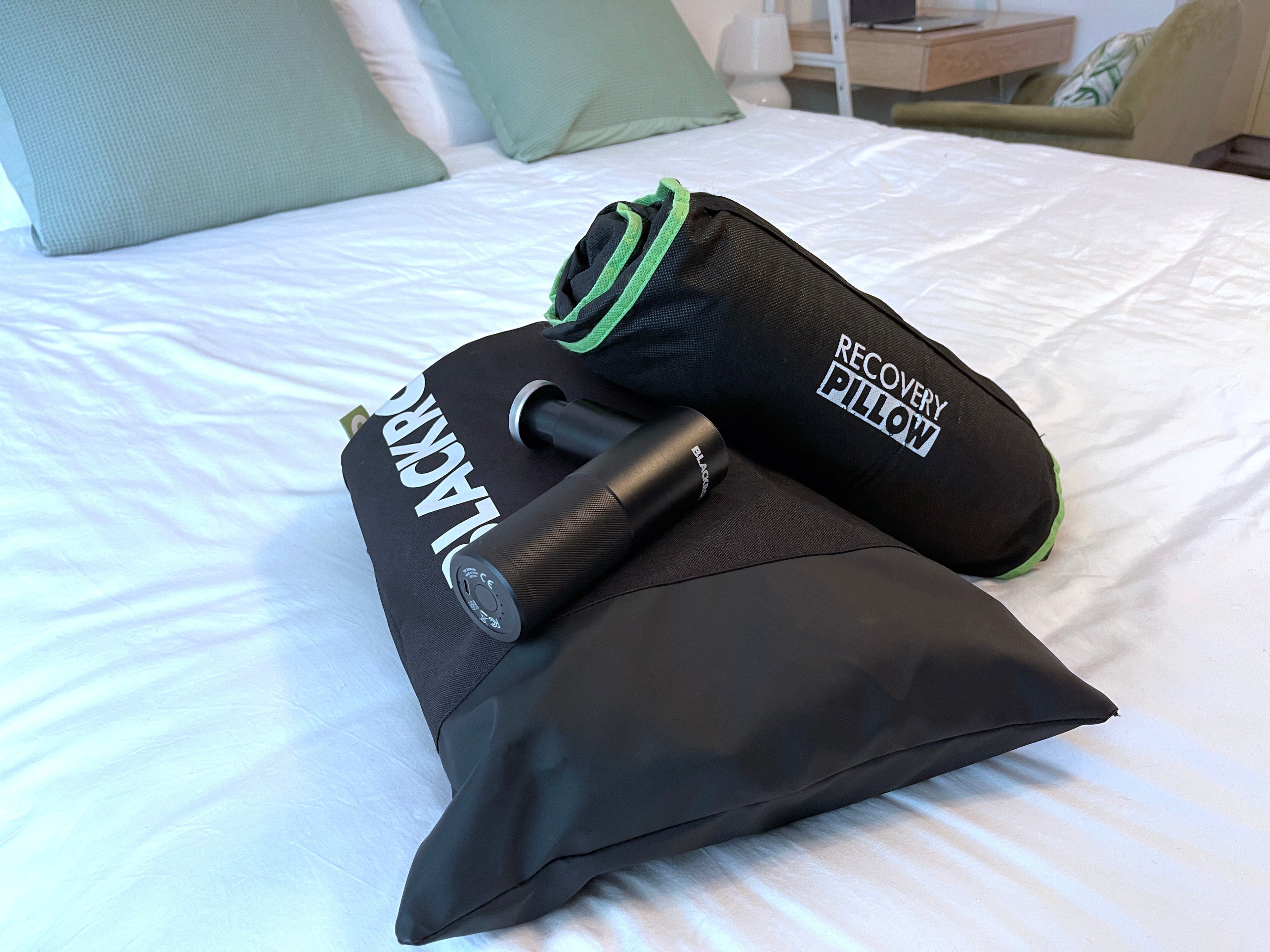 Compact BLACKROLL recovery bundle with compression boots, massage gun, and rollable pillow – portable recovery kit for home, gym, or travel