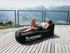 Person relaxing on BLACKROLL Inflatable Lounger outdoors after training session