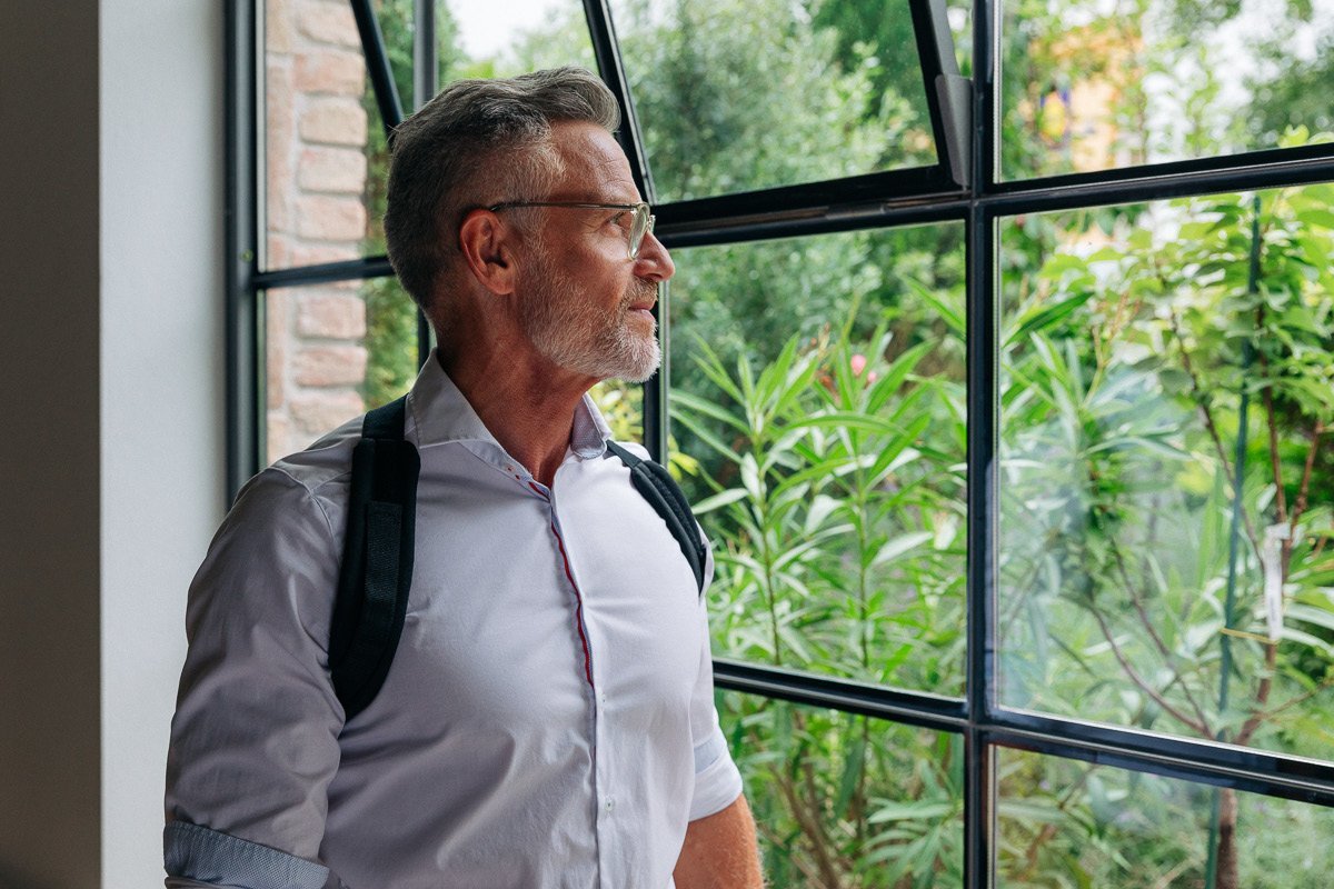 Man using BLACKROLL® POSTURE strap posture brace for desk posture support