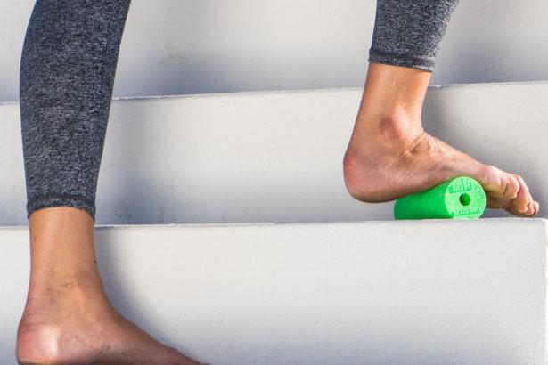athlete using mini foam roller for feet