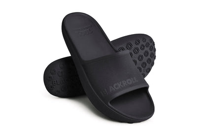 Pair of BLACKROLL recovery sandals in black – designed for post-workout recovery and daily comfort