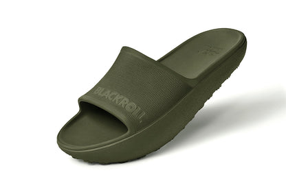 Side view of green BLACKROLL Recovery Slides showing ergonomic heel drop and curved sole